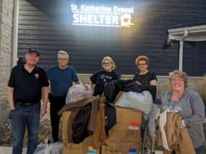 Coats for Kids team outside with coats at St. Katharine Drexel Shelter in Fond du Lac.